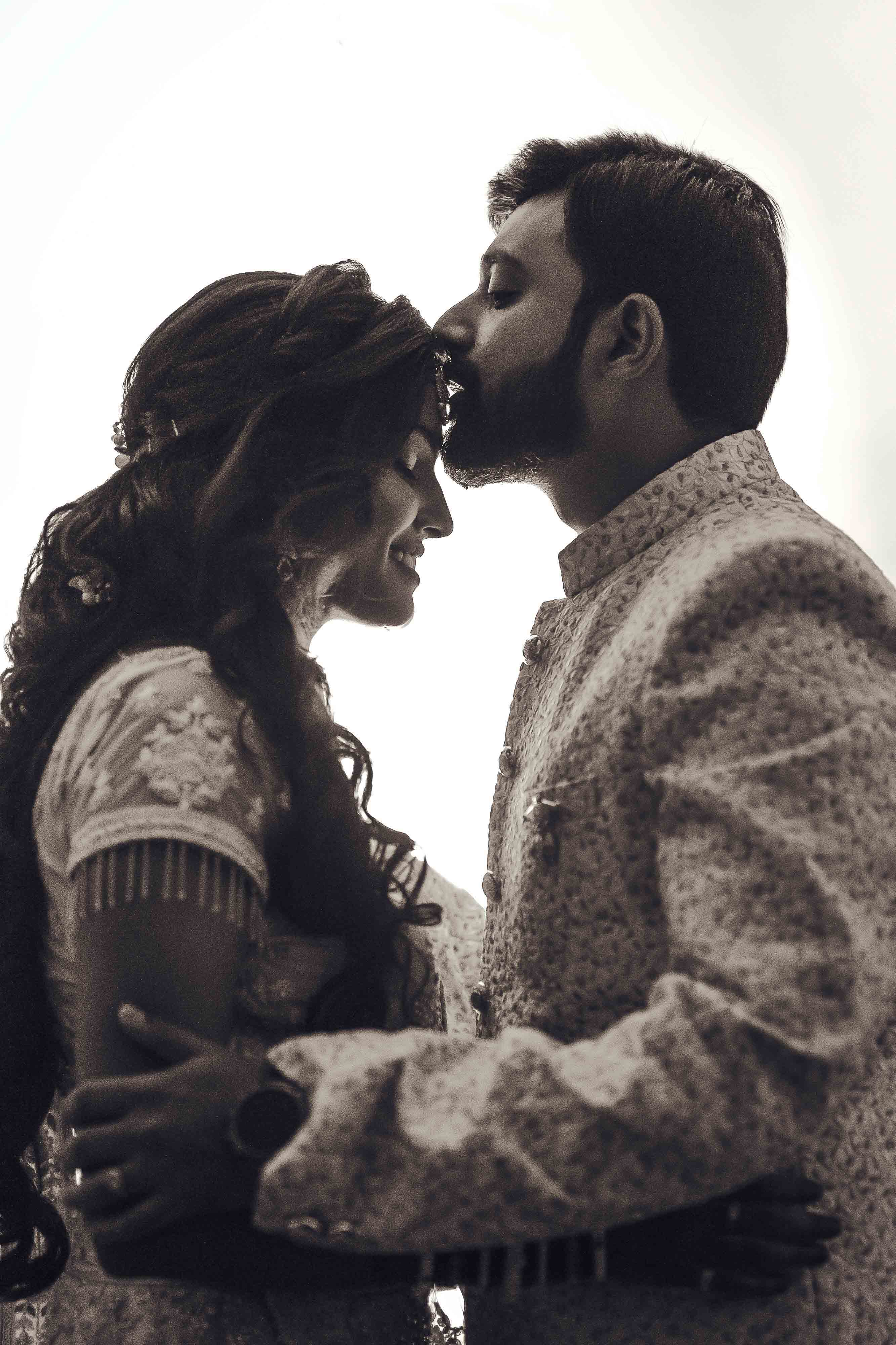 A stunning bride and groom sharing an intimate moment on their wedding day, dressed in elegant attire, perfect for romantic themes.